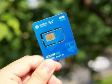 Chinese SIM card held outdoors for mobile data
