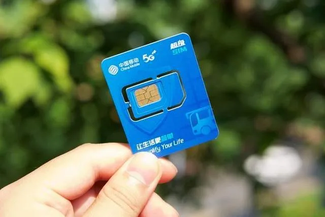 Chinese SIM card held outdoors for mobile data
