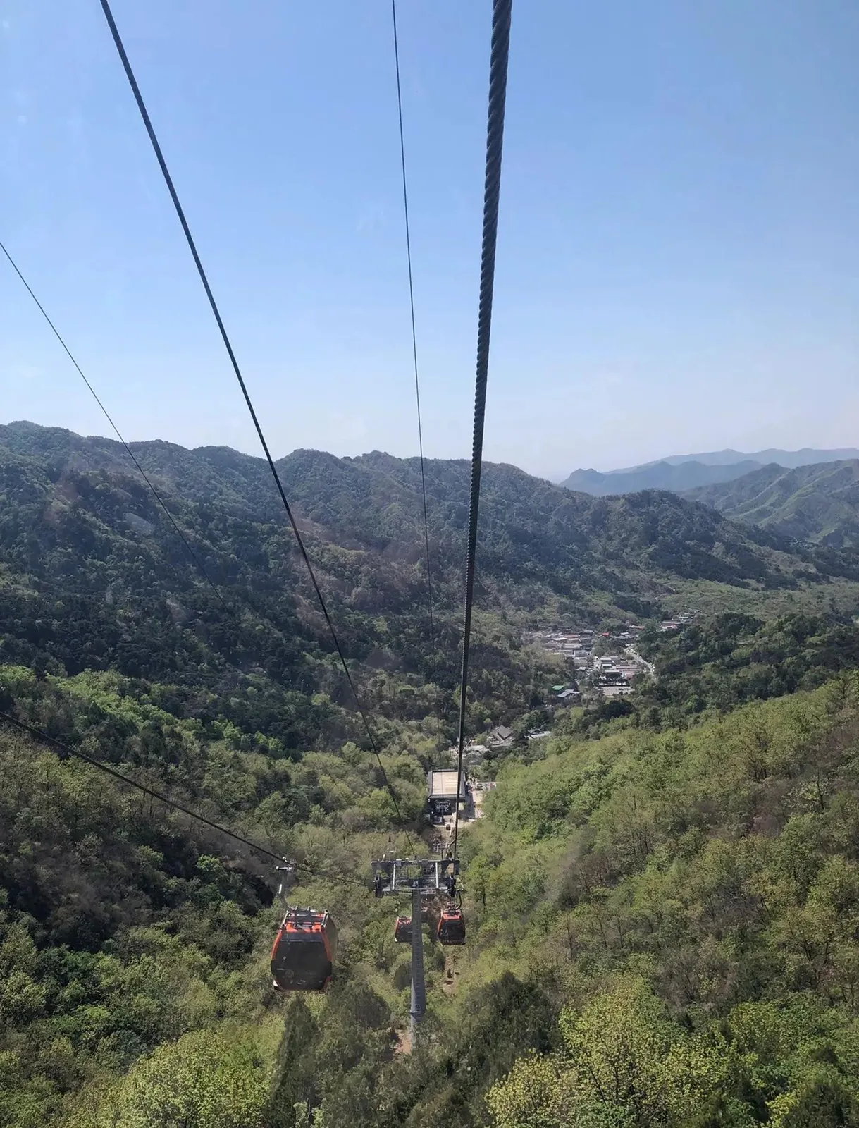Open chairlift chairs above the Mutianyu Great Wall forest