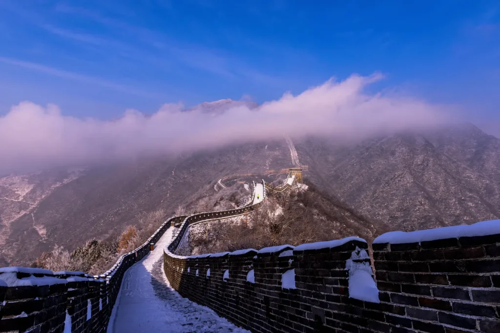Cloud and snow over Mutianyu Great Wall in January winter conditions