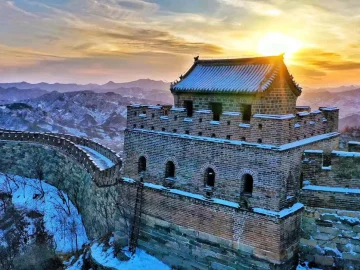 Snowy Mutianyu Great Wall watchtower at sunrise in January