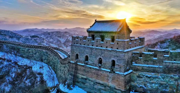 Snowy Mutianyu Great Wall watchtower at sunrise in January