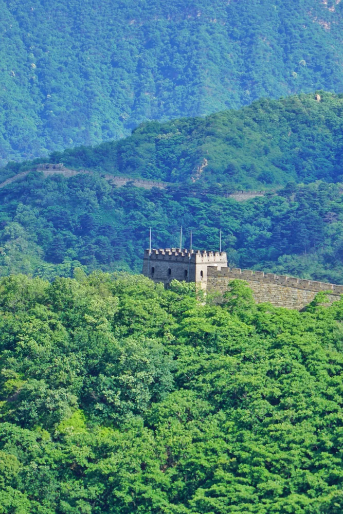 Mutianyu Great Wall watchtower surrounded by green July mountains
