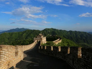 Restored Mutianyu Great Wall ridge with green mountains for first-time visitors