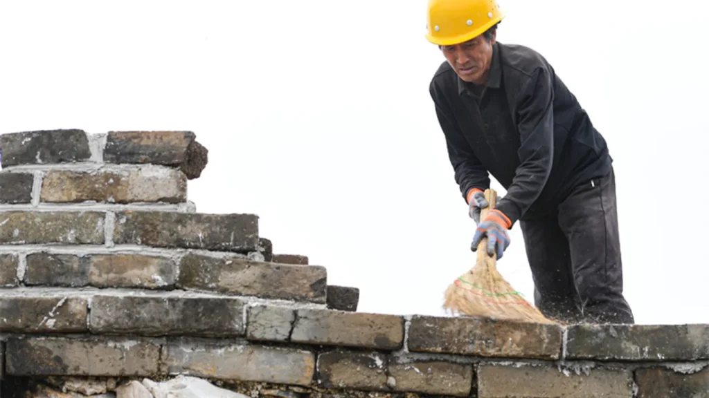 Worker restoring stonework on the Jiankou Great Wall