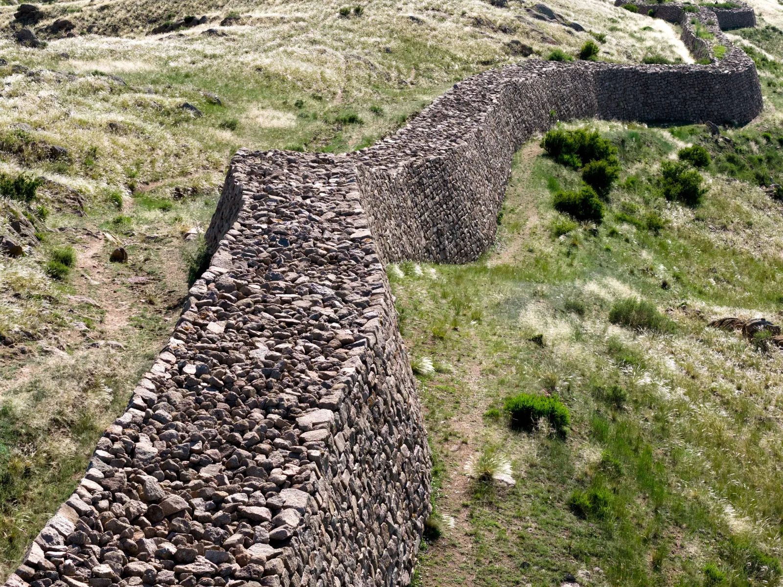 Stone Great Wall remains climbing a dry hillside