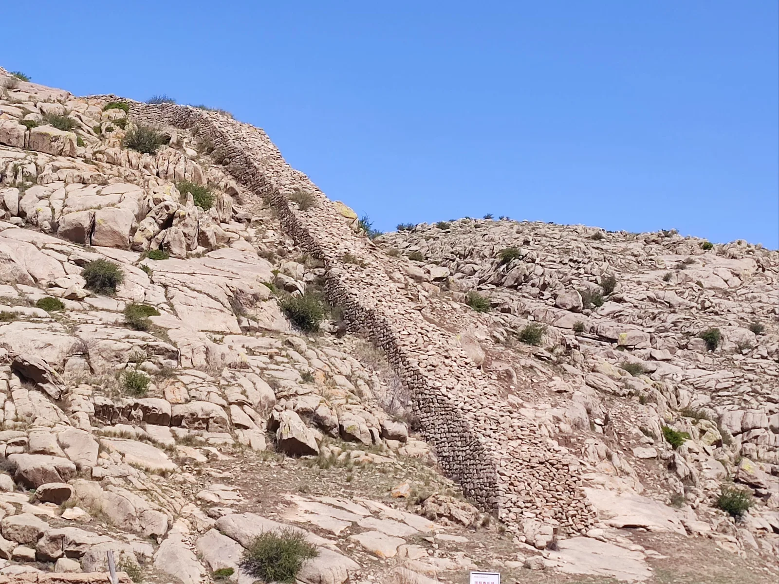 Ancient stonework ruins on a dry Great Wall slope