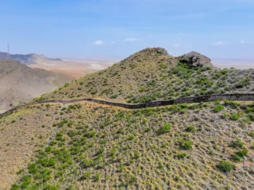 Ancient Great Wall remains across dry hills