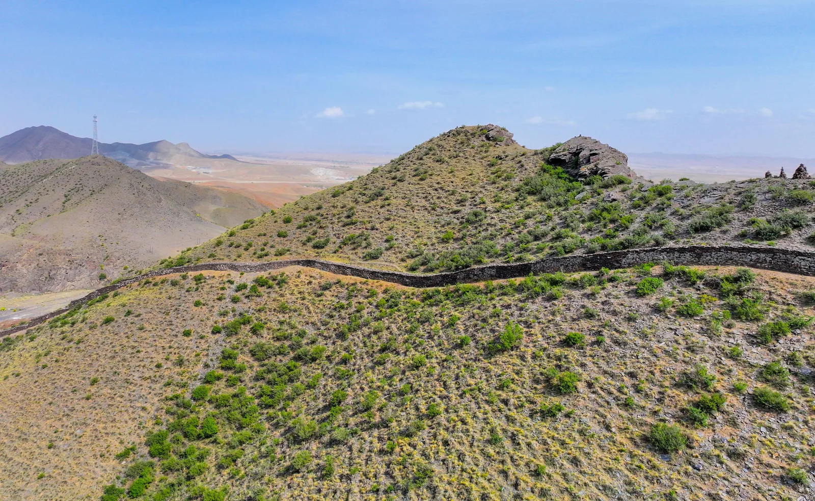 Ancient Great Wall remains across dry hills