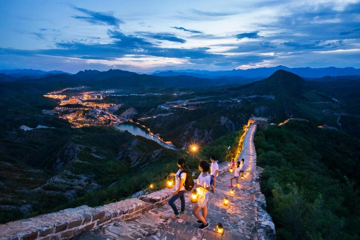 Wide view of Simatai Great Wall lights at dusk