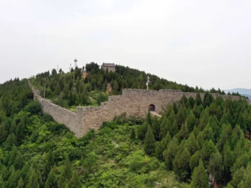 Early Great Wall remains running through forested hills