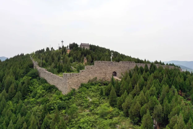 Early Great Wall remains running through forested hills