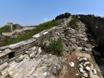 Ruined Great Wall stones on a mountain ridge