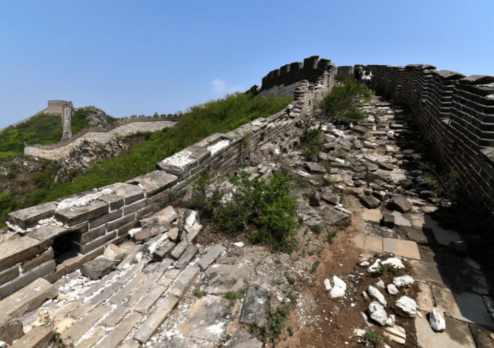 Ruined Great Wall stones on a mountain ridge