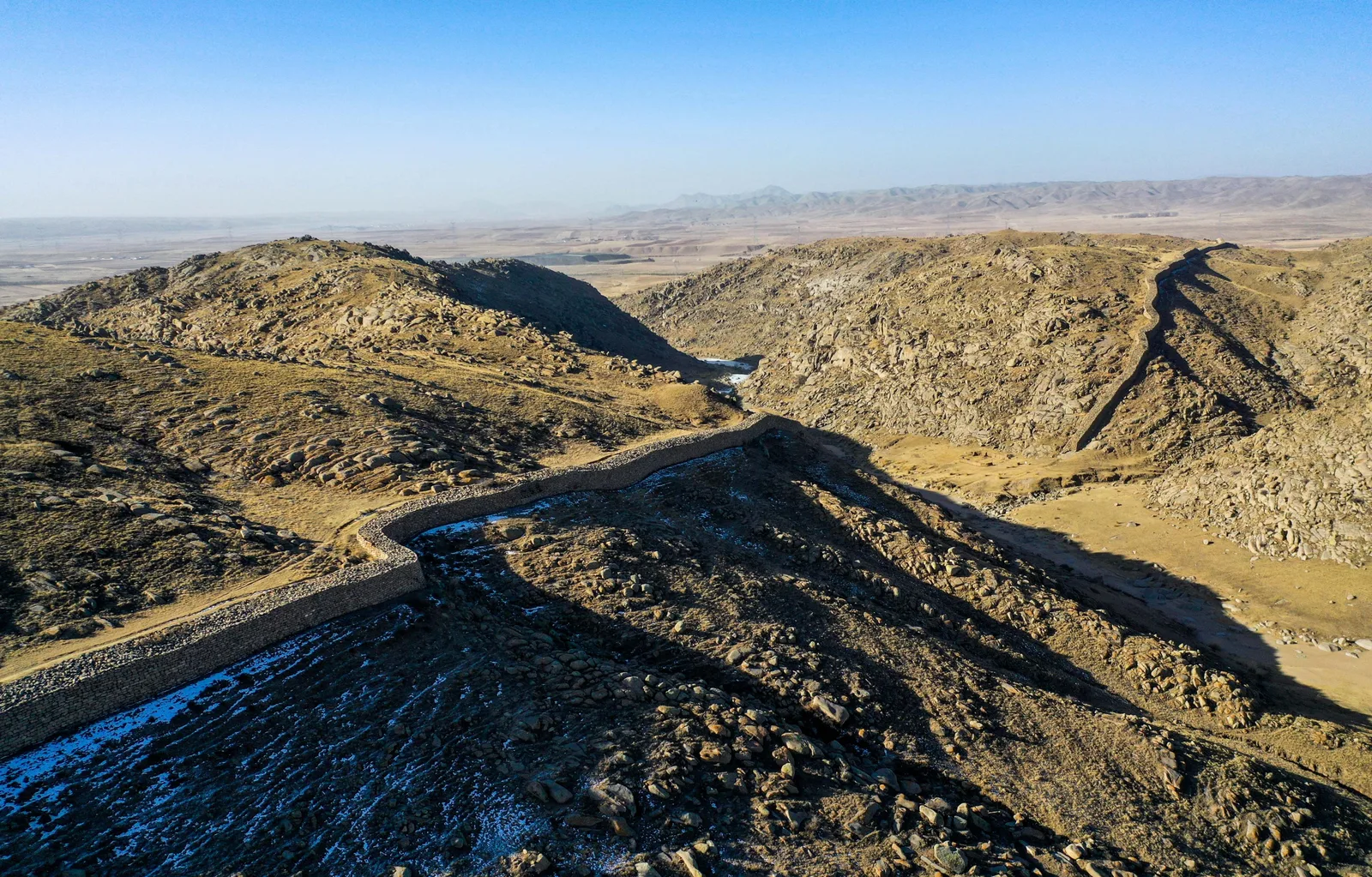 Early Great Wall remains crossing dry mountain ridges