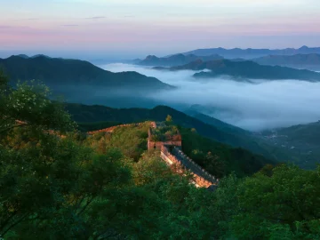 Mutianyu Great Wall in summer after rain with mist over green mountains