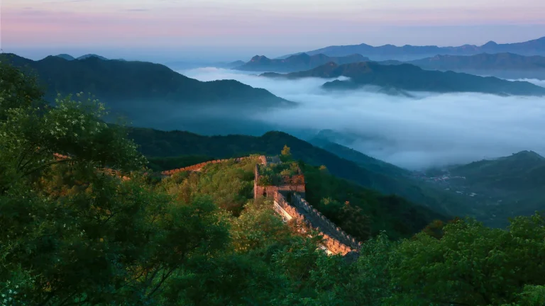 Mutianyu Great Wall in summer after rain with mist over green mountains