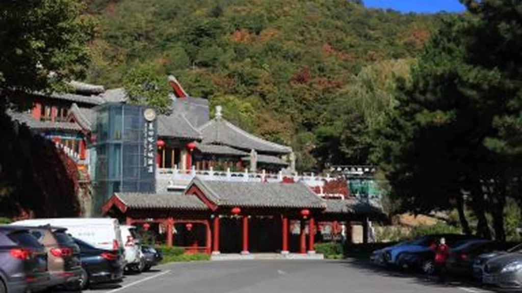 Mutianyu Great Wall arrival area with parking and visitor buildings for layover timing
