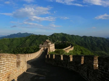 Sunny restored Mutianyu Great Wall watchtower view with green mountain ridges north of Beijing
