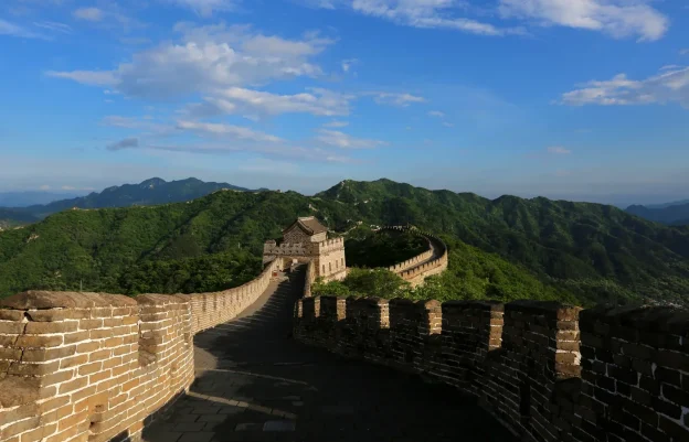Sunny restored Mutianyu Great Wall watchtower view with green mountain ridges north of Beijing
