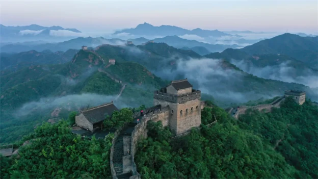 Jinshanling Great Wall watchtowers and mountain ridges in morning mist