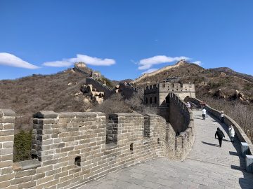 Visitors walking the Badaling Great Wall under a clear blue sky