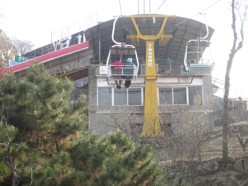 Chairlift rising through the trees at Mutianyu Great Wall