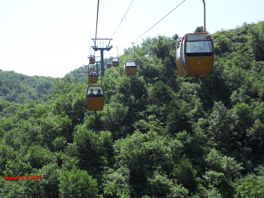 Cable car cabins above the forest at Jinshanling Great Wall