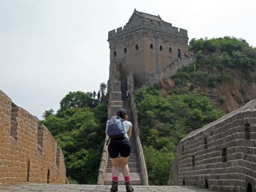 A visitor walking toward a watchtower on the Jinshanling Great Wall