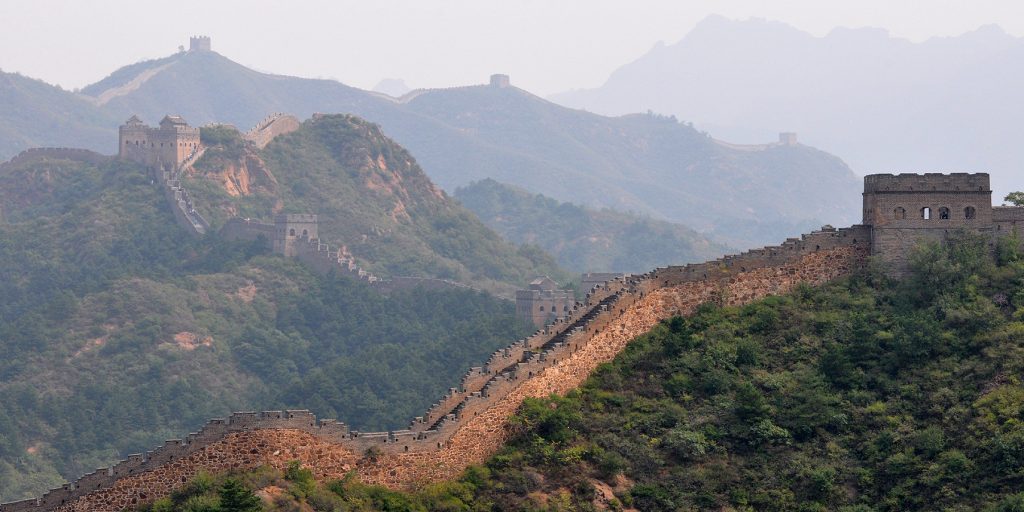Jinshanling Great Wall crossing mountain slopes in hazy light