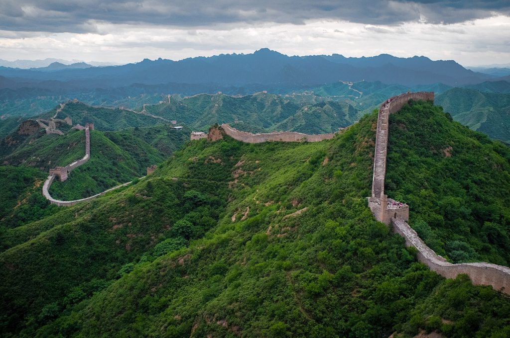 Wide panorama of the Jinshanling Great Wall across green hills