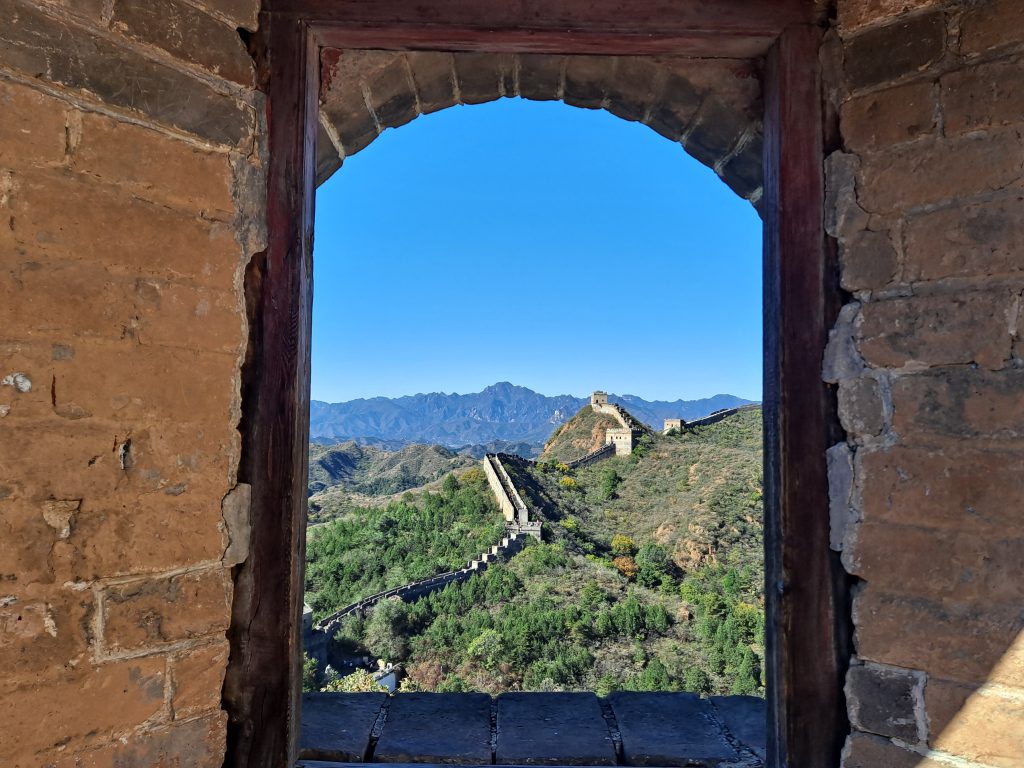 A Great Wall view framed by a watchtower opening at Jinshanling