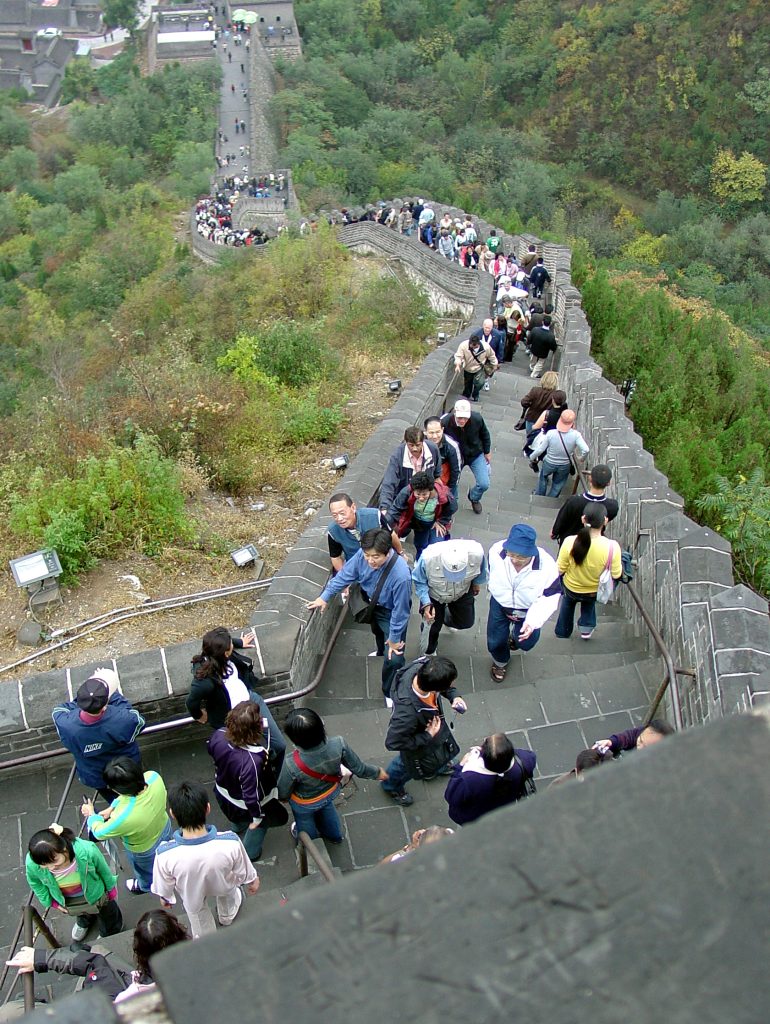 A group of visitors walking together on the steps of Juyongguan Great Wall