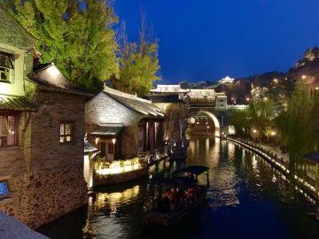Illuminated canal and buildings in Gubei Water Town at night
