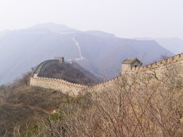 A restored wall ridge at Mutianyu above wooded hills near Beijing