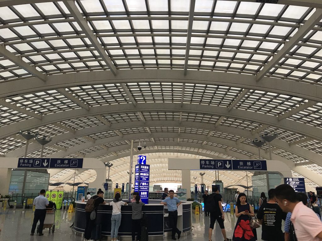 Passengers with luggage in the concourse at Beijing Capital International Airport