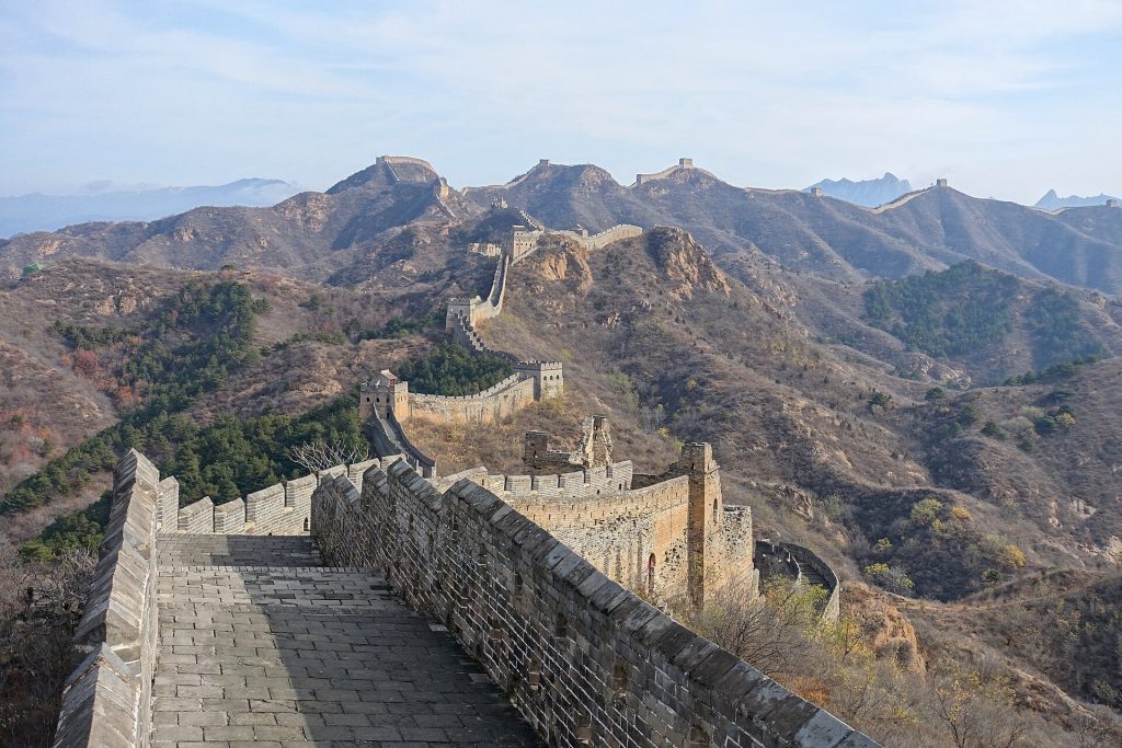 Stone steps and watchtowers along the Jinshanling Great Wall above mountain ridges