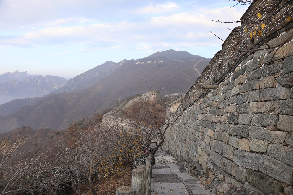 Stone steps and a watchtower on the Mutianyu Great Wall above a mountain valley