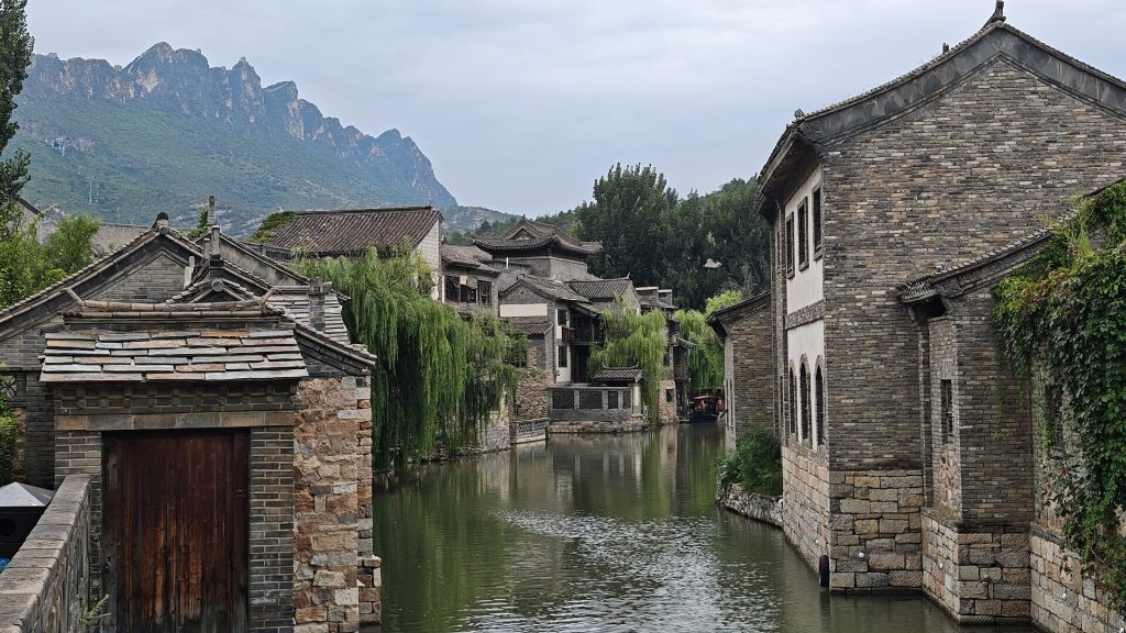 Canal and stone buildings at the Gubei Water Town resort near Simatai