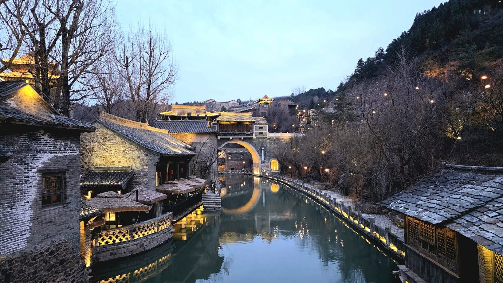 Illuminated canal and bridge at Gubei Water Town after dusk in 2026