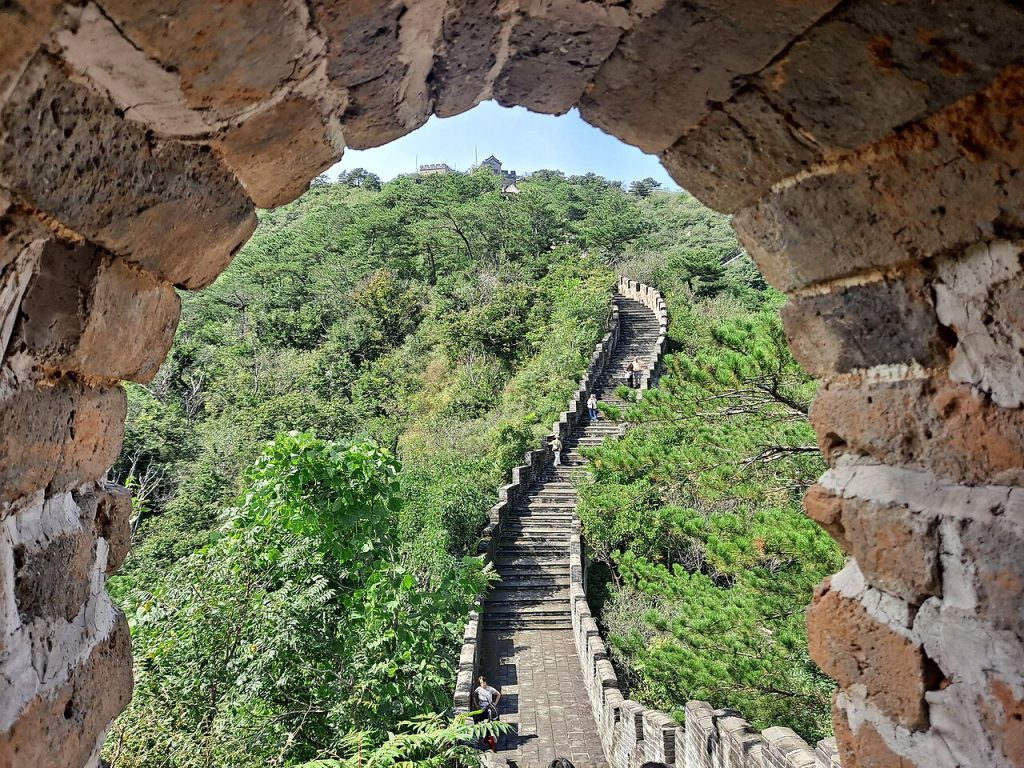 A steep stone staircase on the Great Wall seen through an arched opening at Huanghuacheng