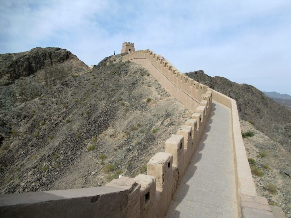 Restored Overhanging Great Wall climbing a rocky hillside near Jiayuguan