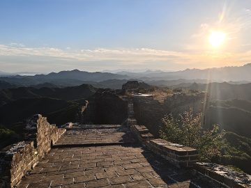 Sunlit Great Wall ridge and watchtowers at Jinshanling in September 2026